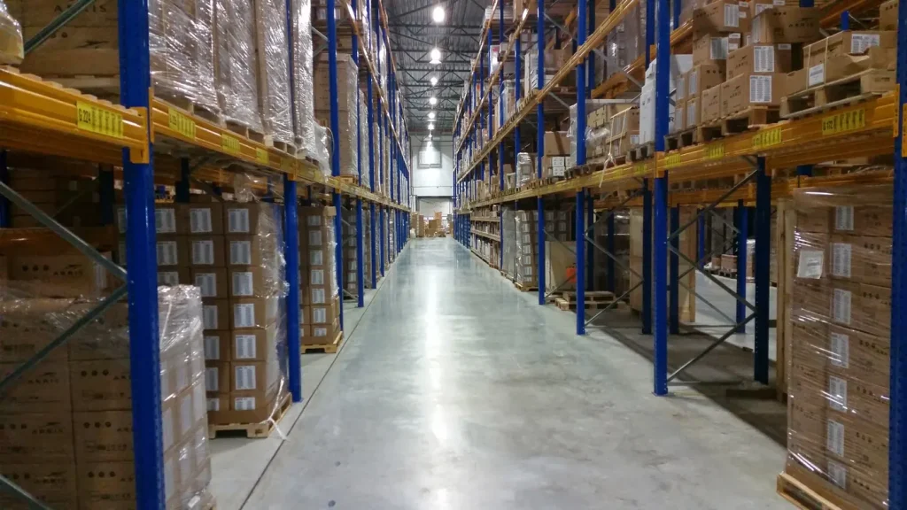Warehouse aisle lined with pallets of boxed stock