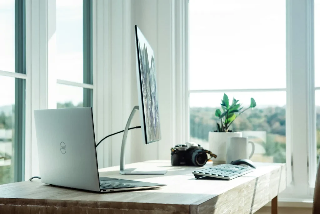 Dell laptop on a desk with a monitor