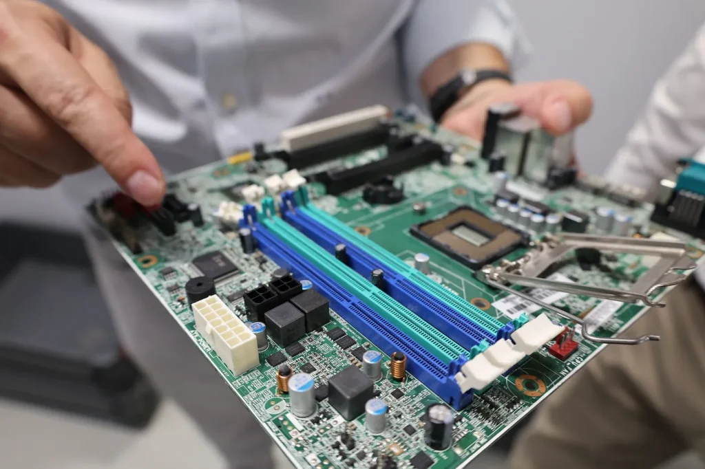 Hands holding a computer motherboard