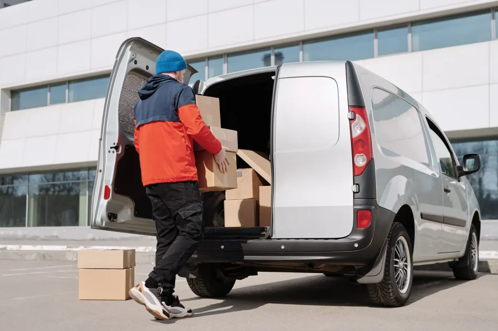 Courier loading parcels into a van